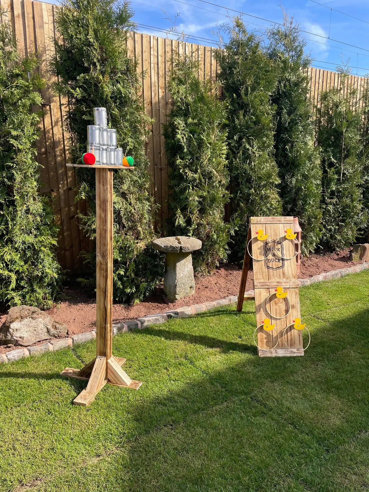 Handmade tin can alley and lawn game set up on a garden lawn