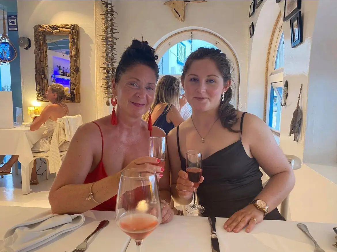 Karen and her daughter Charlotte together at a table with drinks