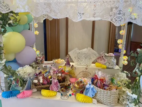 Pastel-themed children’s sweet table with cones, baskets and balloons